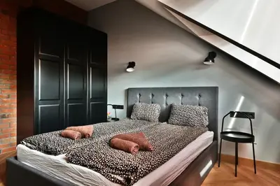a bedroom with a large bed with pillows on it at Domillion New Modern Old town apt 14 ppl U2C2 in Vilnius