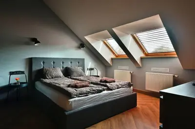 a bedroom with a bed and two skylights at Domillion New Modern Old town apt 14 ppl U2C2 in Vilnius