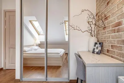 a mirror in a room with a bed and a bedroom at Domillion New 2bdr Old Town Amber apt Z1B5 in Vilnius