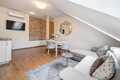 a living room with a couch and a table at Domillion New 2bdr Old Town Amber apt Z1B5 in Vilnius