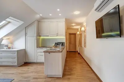 a kitchen with white cabinets and a counter top at Domillion New 2bdr Old Town Amber apt Z1B5 in Vilnius