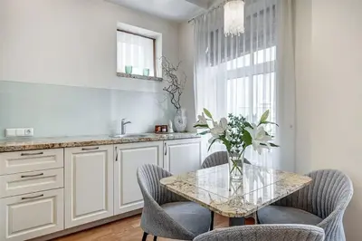 a kitchen with a glass table with chairs and a sink at Domillion New Old Town Amber 1bdr Z1B4 in Vilnius