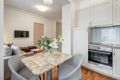 a living room with a table with chairs and a couch at Domillion New Old Town Amber 1bdr Z1B4 in Vilnius