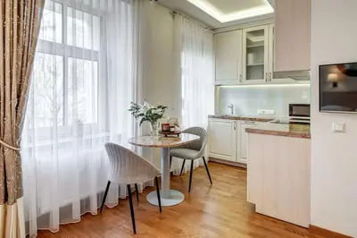 a kitchen with a table and chairs and a window at Domillion New Old Town Amber studio Z1B3 in Vilnius