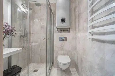 a bathroom with a shower and a toilet and a sink at Domillion New Old Town Amber studio Z1B3 in Vilnius