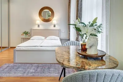 a bedroom with a bed and a table with a coffee table at Domillion New Old Town Amber studio Z1B3 in Vilnius