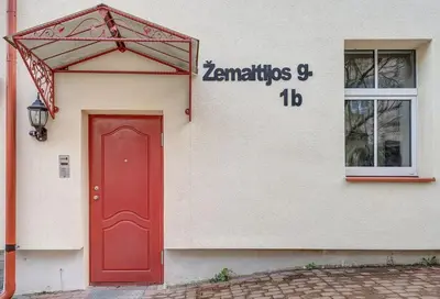 a red door on the side of a building at Domillion New Old Town Amber studio Z1B3 in Vilnius
