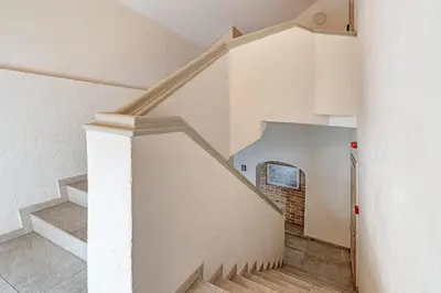 a staircase in a house with a brick wall at Domillion New Old Town Amber studio Z1B3 in Vilnius