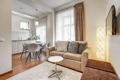 a living room with a couch and a table at Zemaitijos Versatile 12ppl Triplex in Vilnius