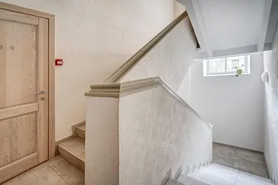 a staircase in a home with a stair case at Zemaitijos Versatile 12ppl Triplex in Vilnius