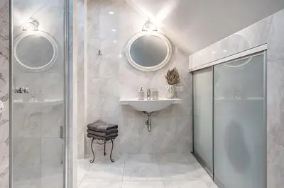 a bathroom with a sink and a shower at Zemaitijos Versatile 12ppl Triplex in Vilnius