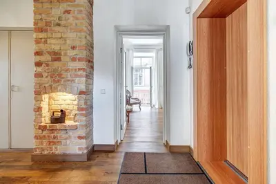 a hallway with a brick fireplace in a house at Domillion 2bdr Vilnius str antique apt Vl476 in Vilnius