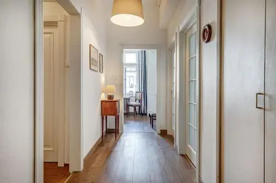 a hallway with a table and a desk in a room at Domillion 2bdr Vilnius str antique apt Vl476 in Vilnius