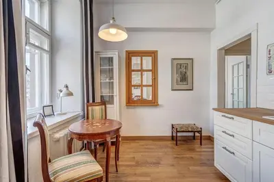 a kitchen with a table and a table and chairs at Domillion 2bdr Vilnius str antique apt Vl476 in Vilnius