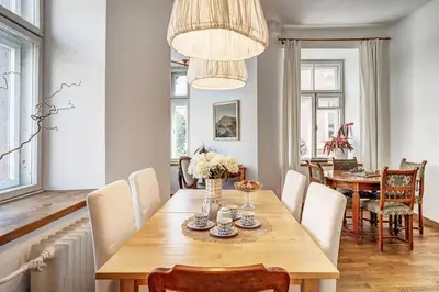a dining room with a wooden table and chairs at Domillion 2bdr Vilnius str antique apt Vl476 in Vilnius