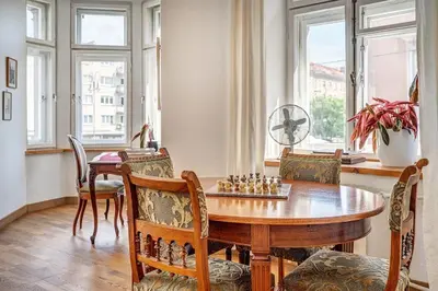 a dining room with a chessboard on a wooden table at Domillion 2bdr Vilnius str antique apt Vl476 in Vilnius