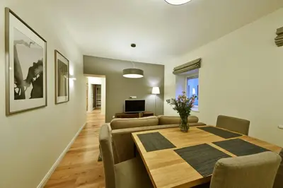 a living room with a dining room table and a couch at Domillion old town duplex 14ppl free parking L4D in Vilnius