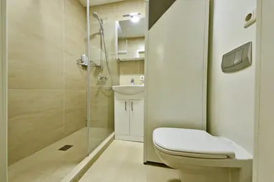 a bathroom with a shower and a toilet and a sink at Domillion old town duplex 14ppl free parking L4D in Vilnius