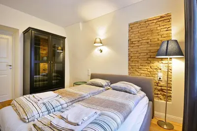 a bedroom with a bed with towels on it at Domillion old town duplex 14ppl free parking L4D in Vilnius