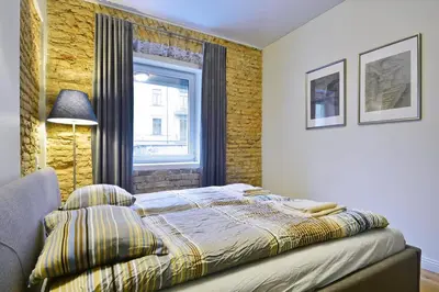 a bedroom with a bed and a window in it at Domillion old town duplex 14ppl free parking L4D in Vilnius