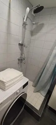 a bathroom with a shower with a towel on a counter at Kosmonautų gatve in Panevėžys
