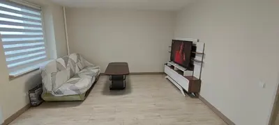 a living room with a couch and a tv at Kosmonautų gatve in Panevėžys