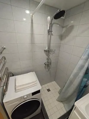 a bathroom with a shower with a toilet and a sink at Kosmonautų gatve in Panevėžys