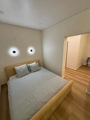 a bedroom with a bed with two pillows on it at 13 New Airport Apartment in VNO