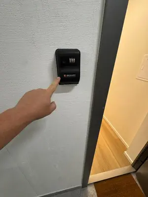 a person pointing at a lightswitch on a door at 13 New Airport Apartment in VNO