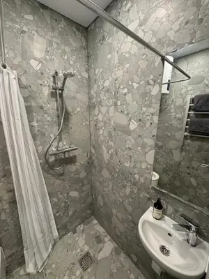 a bathroom with a shower and a sink at 13 New Airport Apartment in VNO