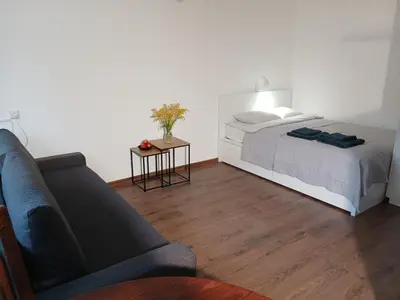 a bedroom with a bed and a couch at Alytus Studio 45 in Alytus