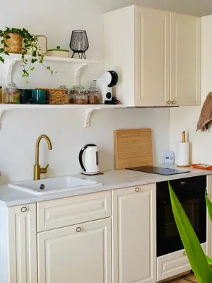 a kitchen with white cabinets and a sink at Old Town Riverside Haven in Vilnius