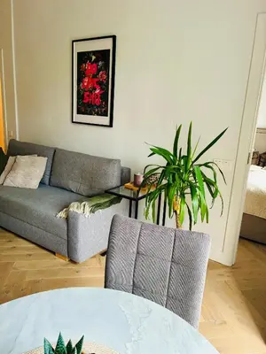 a living room with a couch and a table at Old Town Riverside Haven in Vilnius