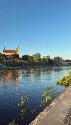 a body of water with some plants in it at Old Town Riverside Haven in Vilnius