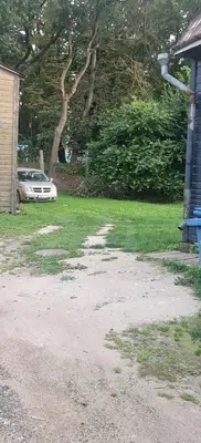 a yard with a car parked next to a house at Vilmos studija in Šiauliai