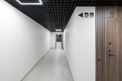 an empty hallway with a ceiling with an arrow sign on it at Vilnius Central Modern Apartments Vepriai Street in Vilnius