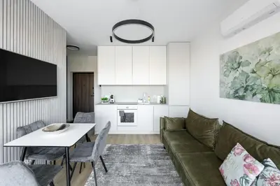 a living room with a couch and a table at Vilnius Central Modern Apartments Vepriai Street in Vilnius