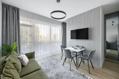 a living room with a couch and a table at Vilnius Central Modern Apartments Vepriai Street in Vilnius