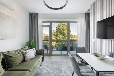 a living room with a couch and a table at Vilnius Central Modern Apartments Vepriai Street in Vilnius