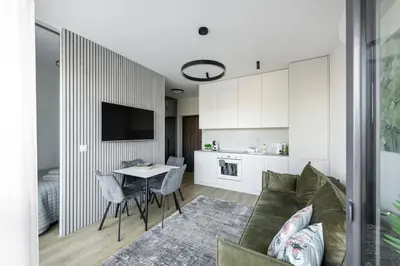 a living room with a couch and a table at Vilnius Central Modern Apartments Vepriai Street in Vilnius