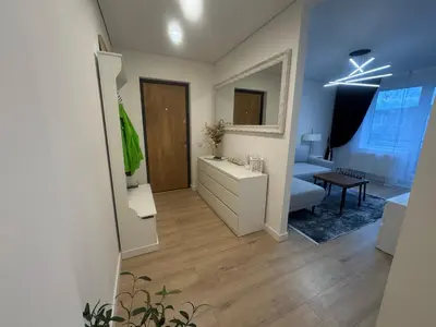 a living room with a sink and a mirror at The Hidden Gem Rukla in Rukla