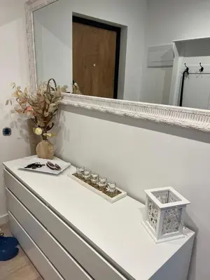 a white dresser with a mirror on top of it at The Hidden Gem Rukla in Rukla