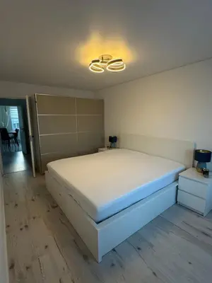 a bedroom with a white bed and a light at The Hidden Gem Rukla in Rukla
