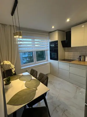 a kitchen and dining room with a table and chairs at The Hidden Gem Rukla in Rukla