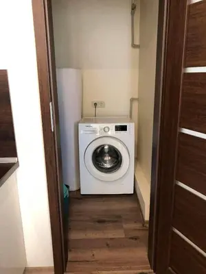 a washer and dryer in a small room at Projektuotojų Apartamentai in Panevėžys
