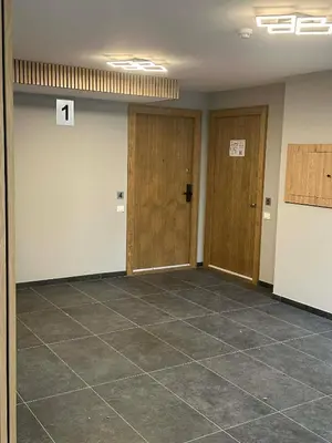 an empty room with two doors and a tile floor at Holiday home in Birstonas in Birštonas