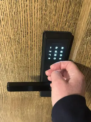 a person holding a remote control with their hand at Holiday home in Birstonas in Birštonas