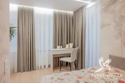 a bedroom with a desk and a bed at SarkuGuzta Cozy Apartment in Kaunas