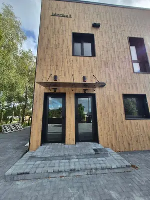 a building with two glass doors in front of it at Marių namai in Kaunas