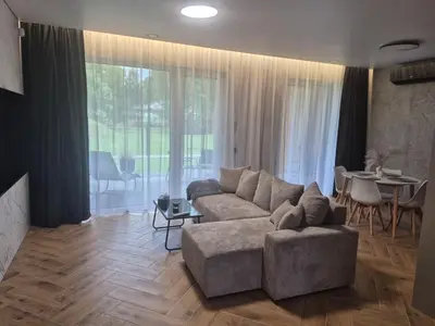 a living room with a couch and a table at Marių namai in Kaunas